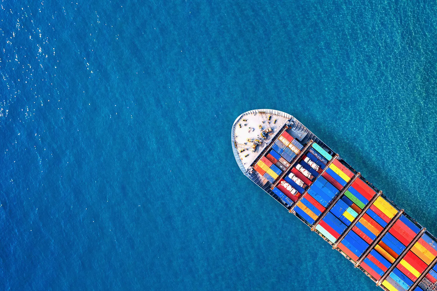 Aerial view of cargo ship and cargo containers in harbor